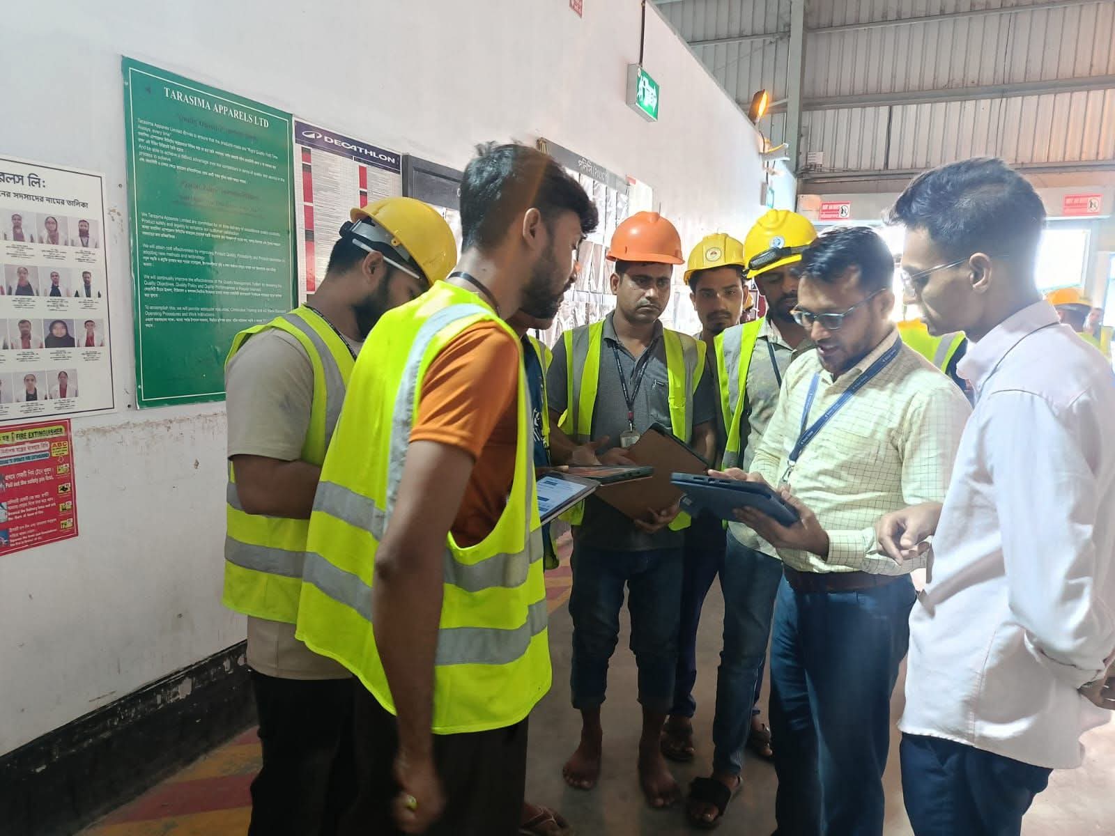 Quality team reviewing an inspection on a tablet on the factory floor